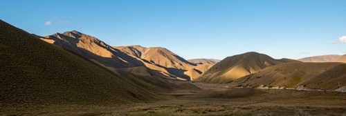 Barren mountain landscape with tufts of grass