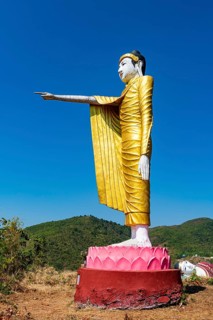 Large standing buddha on a hill
