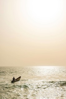 Man going out to sea in his dugout canoe