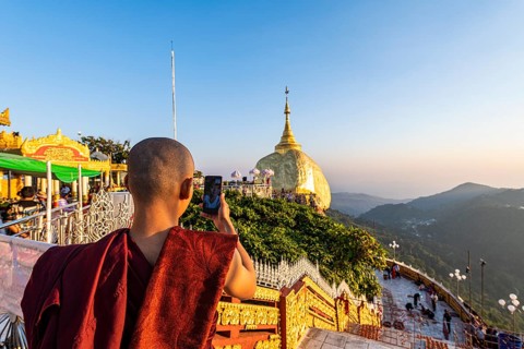 Monk photographing the Kyaiktiyo Pagoda