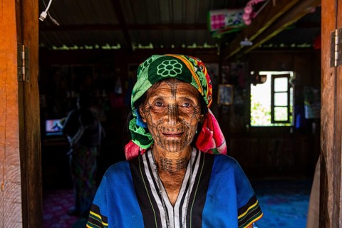 Chin woman with spiderweb tattoo
