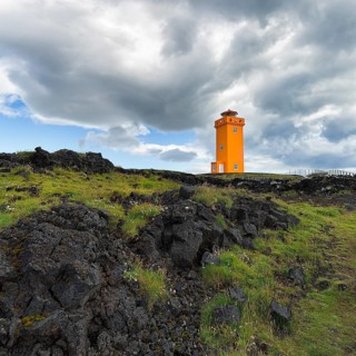 Orange lighthouse Skalasnagaviti or Svoertuloft at cliff