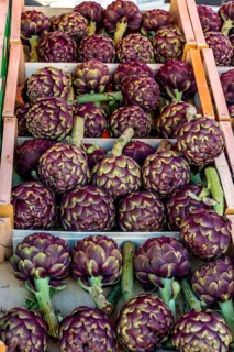 Crate of artichokes on a market stale