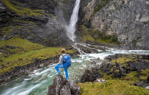 Hiker standing by river Driva