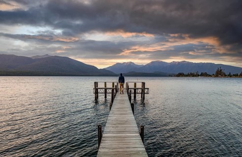 Juger man on jetty at lake