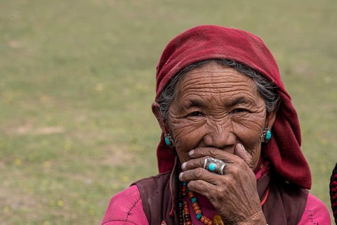 Portrait of an elderly woman with turquoise earring and finger ring