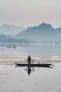 Fisherman in his canoe fishing