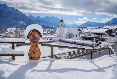 Village view with parish church and Karwendel mountains