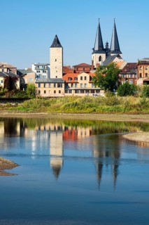 Witch tower and Stephani church reflected in the river Saale