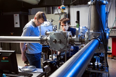 PhD student during his research work adjusting his experimental setup