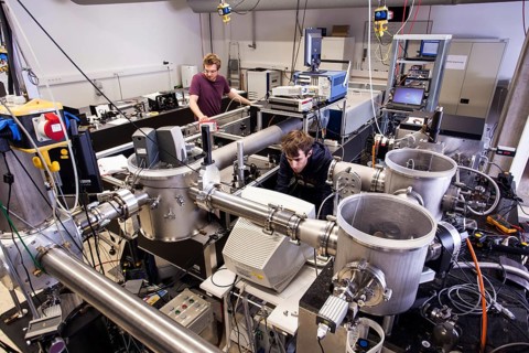PhD student during his research work adjusting his experimental setup