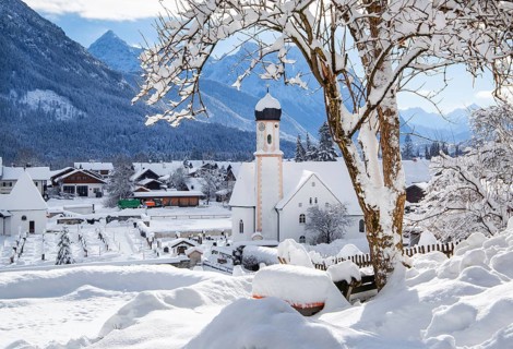 Village view with parish church and Karwendel mountains