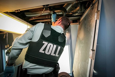 Customs officer searches for contraband and narcotics in ICE train on Rhine Valley route to Switzerland