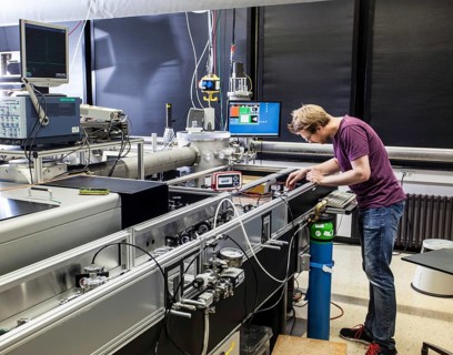 PhD student during his research work adjusting his experimental setup