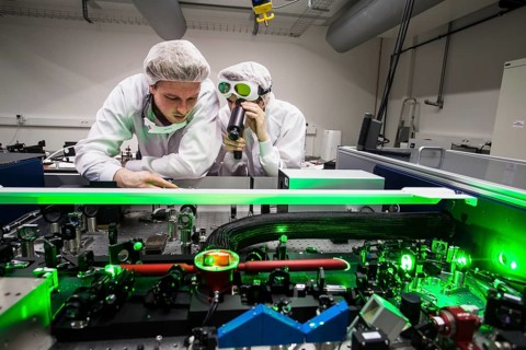 PhD student during his research work adjusting his experimental setup