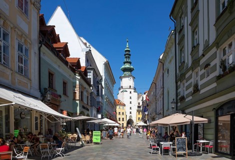 Pedestrian zone with restaurants in Michalska Street with Michael's Gate