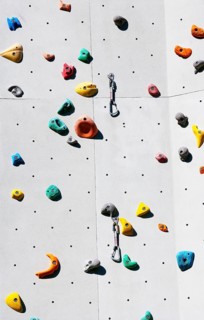 Handles hooks and eyes on a climbing wall