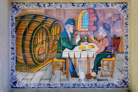 Funny painted tiles representing two men drinking wine