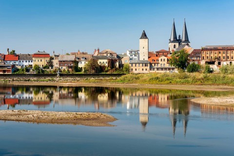 Old town with witch tower and Stephani church reflected in the river Saale