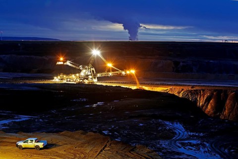 Opencast lignite mine with stacker in the evening