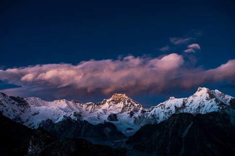 View in the evening light from Renjo La Pass 5417 m to the east on Himalaya with Gyachung Kang