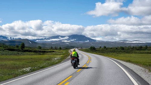 Motorcyclists on road through tundra