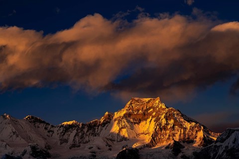 View in the evening light from Renjo La Pass 5417 m to the east on Himalaya with Gyachung Kang