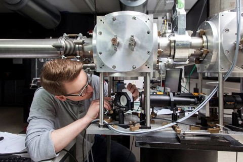 PhD student during his research work adjusting his experimental setup