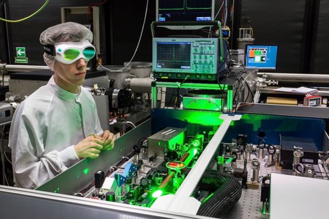 PhD student during his research work adjusting his experimental setup
