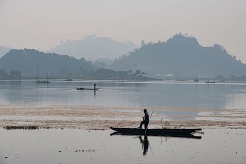 Fisherman in his canoe fishing