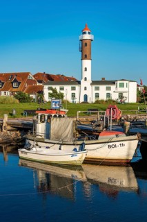 Fishing boats and lighthouse in the harbour of Timmendorf on the island of Poel