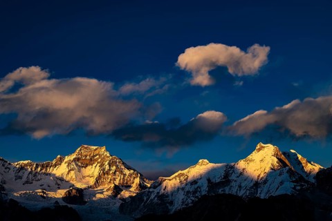 View in the evening light from Renjo La Pass 5417 m to the east on Himalaya with Gyachung Kang