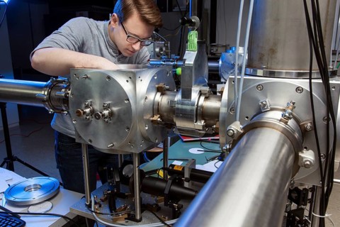 PhD student during his research work adjusting his experimental setup