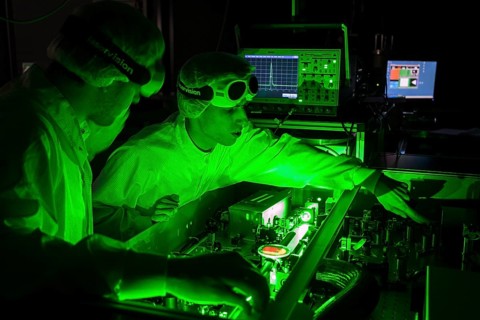 PhD student during his research work adjusting his experimental setup