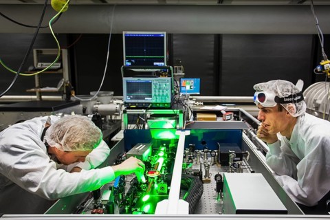 PhD student during his research work adjusting his experimental setup