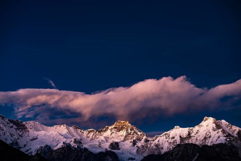 View in the evening light from Renjo La Pass 5417 m to the east on Himalaya with Gyachung Kang