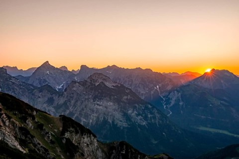 Sunset behind mountain silhouette
