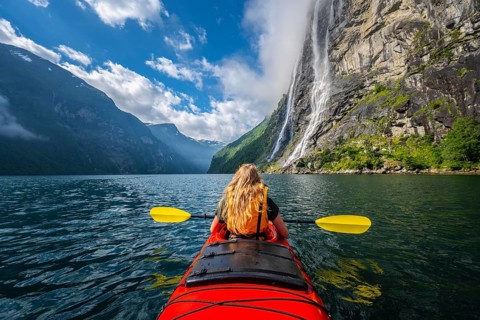 Young woman paddling in a kayak