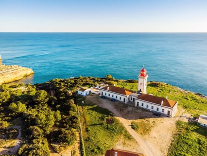 Cliffy coast of Algarve with Alfazinha Lighthouse in Carvoeiro