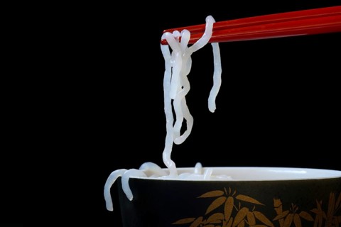 Shirataki noodles made from konjac flour on chopsticks