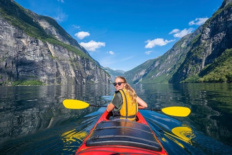 Young woman paddling in a kayak
