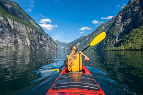 Young woman paddling in a kayak
