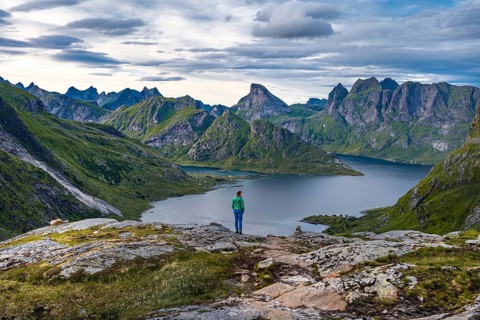 Hiker walks through mountain landscape