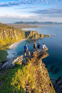 Four hikers standing on rocky outcrop