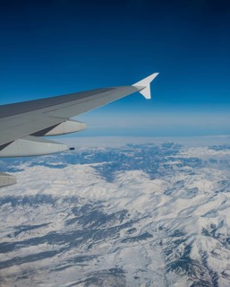 View of mountains and snowy landscape from the airplane