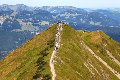 Hiker on the ridge trail Fellhorngrat between Fellhorn summit and Soellerkopf