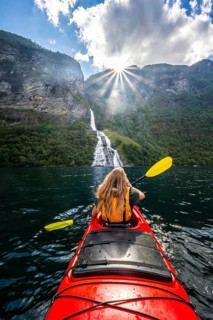 Young woman paddling in a kayak