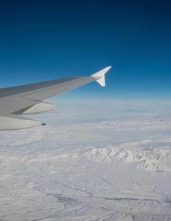 View of mountains and snowy landscape from the airplane