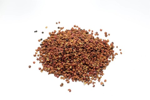 Sichuan peppercorns against a white background