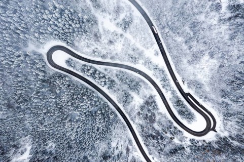 Winter snow road serpentines S-curve curves Lochenpass forest aerial photo way curve
